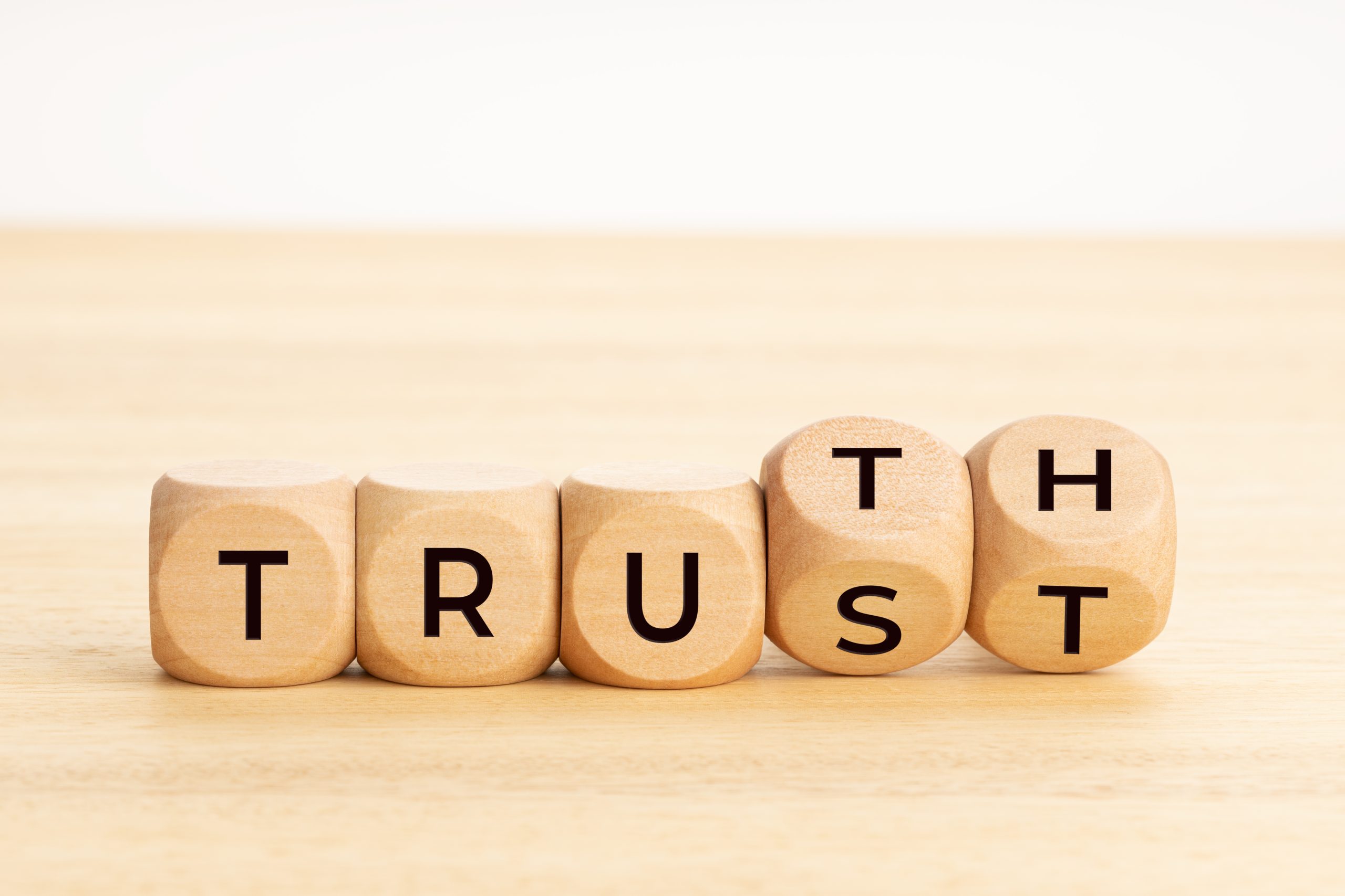 Truth or trust concept. Text on wooden blocks. White background. Copy space Truth or trust concept. Text on wooden blocks. White background. Copy space