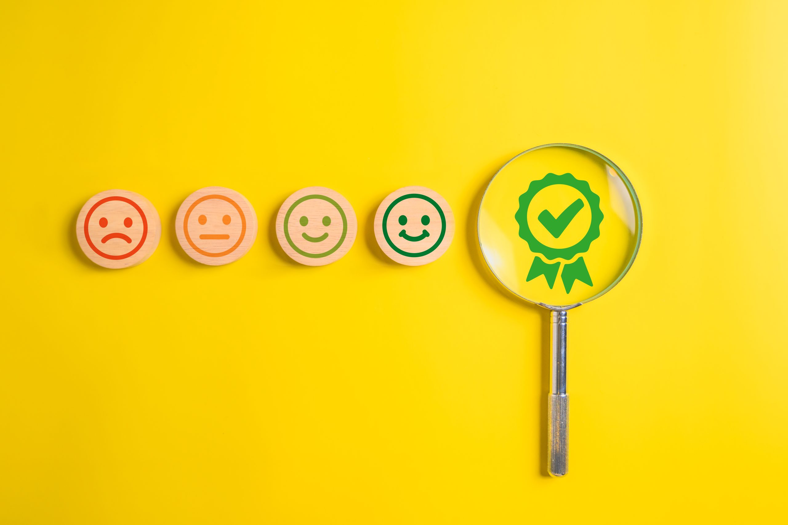 satisfaction with smiley face emoticon on wooden yellow background. satisfaction with smiley face emoticon on wooden yellow background. High quality photo
